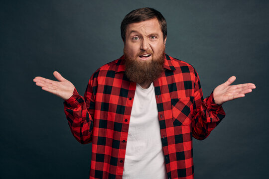 Clueless disappointed angry male client shocked with bad service, spread hands sideways in dismay and distressed, arguing looking questioned and frustrated, complain or condone someone