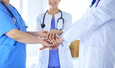Group of doctors putting their hands together. Close-up
