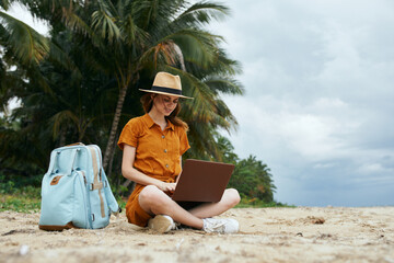 woman tourist backpack travel island tropics laptop technology