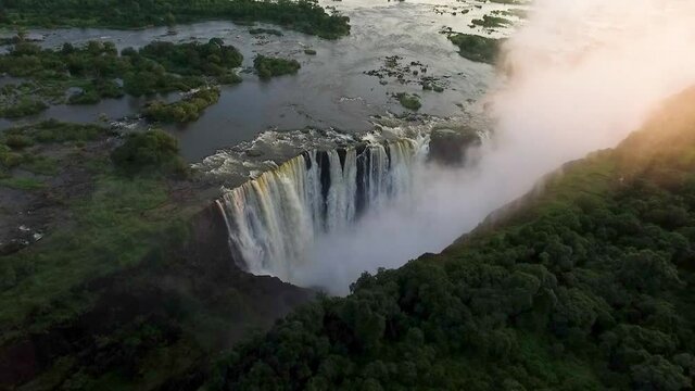 The Victoria Falls at the Border of Zimbabwe and Zambia in Africa. Victoria Falls One of the Most Beautiful Wonders of the World. Aerial Shot from above. Famous waterfall in Africa. Border with Zambia