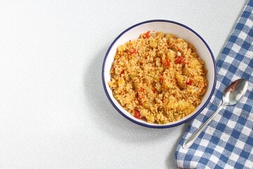 Top view of bulgur pilaf isolated on white background with copy space.