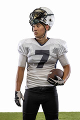 Portrait of young American football player, athlete in sports equipment standing isolated on white studio background. Concept of professional sport, championship, competition.