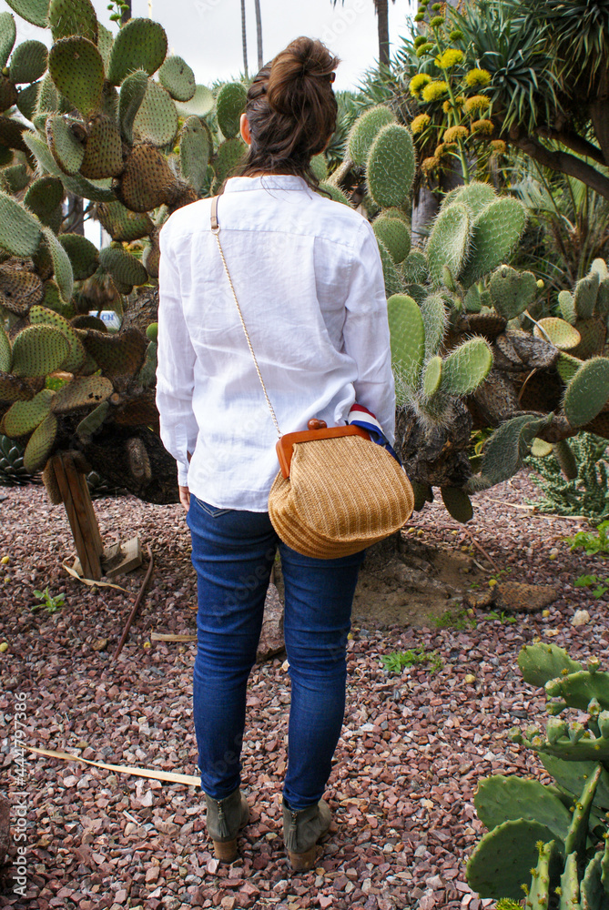 Wall mural Woman with Purse in Urban Garden