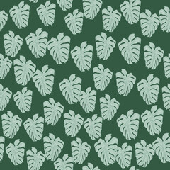 Modern tropical leaves philodendron plant silhouette backdrop. Exotic wallpaper. Chaotic monstera leaf seamless pattern on green background. V