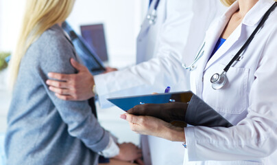 Handsome male doctor consulting a couple about infertility in his medical office