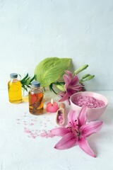 
Fresh flower, burning candles, sea salt, oil and herbal tincture on the table, natural cosmetics for care and relaxation