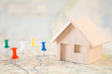 Selective focus of Red pin and house model on map background  for real estate concept