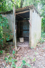 Fototapeta na wymiar old abandoned steel and wood outhouse in the countryside of the Caribbean mountains in the Dominican Republic.