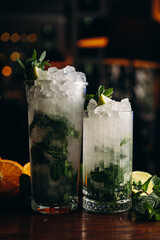 Fresh mojito in glasses on wooden table
