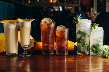 Classic long drink cocktails on the table. Mojito, long island and pina colada