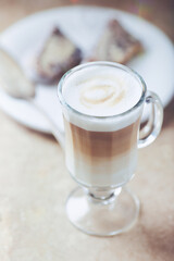 Coffee with milk on bright stone background. Close up.	