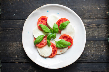 caprese salad mozzarella cheese, tomato meal snack copy space food background rustic. top view keto or paleo diet veggie vegan or vegetarian food