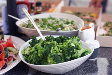 Bowl of superfood green vegetables on a table including broccoli and peas