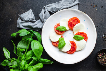 caprese salad mozzarella cheese, tomato meal snack copy space food background rustic. top view keto or paleo diet veggie vegan or vegetarian food