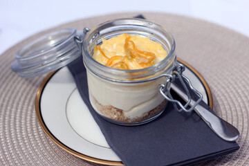 Lemon Cheesecake in ornate jar on napkin and plate