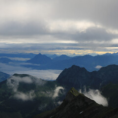 Sunrise scene seen from Mount Brienzer Rothorn. View towards Stanserhorn and Lucerne. Fog lifting slowly after a rainy night.