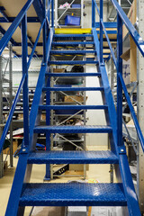 Metal blue staircase in a warehouse.