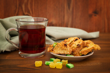 Dried white bread croutons, candied fruit bun and a cup of tea. Cracker with candied fruits.