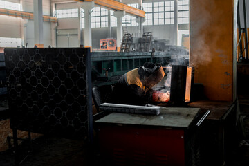 Welder conducts welding work in mask