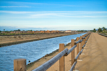 Water lined with wooden fence at Bolsa Chica Ecological Reserve in California