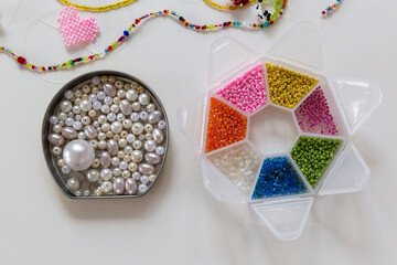 Creative, bright and colorful beads organized in boxes. Handicraft workplace. Beautiful diy jewelry and calming stress relieving hobby and activity
