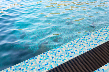 Obraz premium A place by the pool. Mosaic side of the swimming pool. Active recreation. Swimming section. Azure water. Background