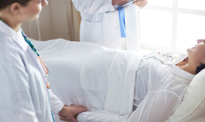 doctor or nurse talking to patient in hospital