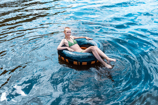 Teen Girl Swimming Using A Swim Tube