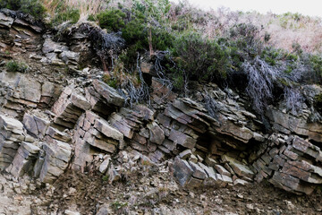 Dolomite, rock wall with a field of grass on top of it