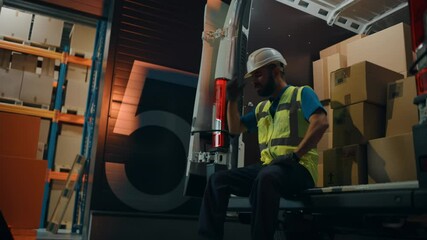 Latin Male Worker Wearing Hard Hat Loads Cardboard Boxes into Delivery Truck, Rests. Online Orders, E-Commerce Goods, Food, Medicine. Tired Overworked Frontline Hero. Dramatic Cinematic Handheld