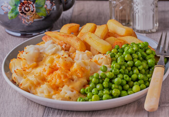 Fish pie with chips and garden peas.