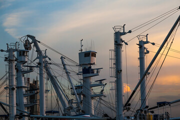 Towers, beams, booms and ropes of cargo cranes on fishing vessels.