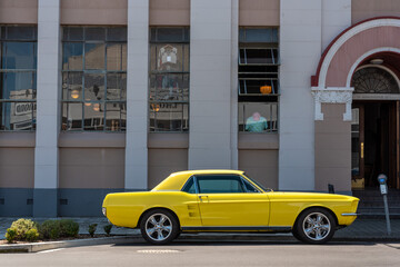 Vintage car parking in front of an Art Deco building in downtown Napier, New Zealand