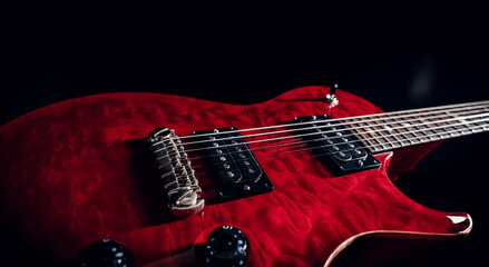 Closeup of a red shiny electric guitar body showing pickups, strings and mechanics