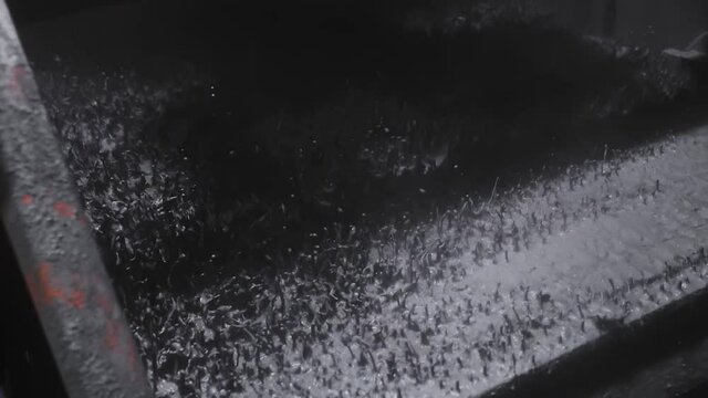 Oil rig shale shaker separating cuttings from drilling mud in slow motion