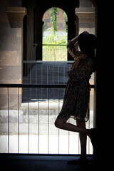 beautiful girl looking out balcony back view