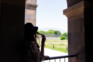 beautiful girl looking out balcony back view