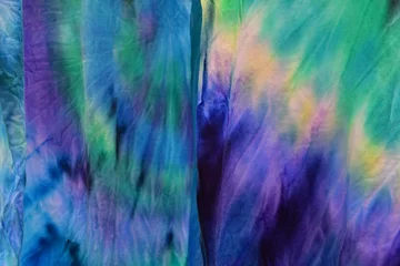 Photo sur Plexiglas Mélange de couleurs Abstract painted background. Multi-colored pattern in the shibori technique on a thin knitted fabric. Multi-color texture. batik.Textile shibori