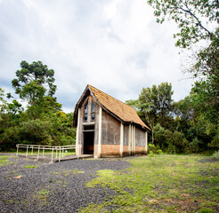 Fototapeta na wymiar Prudentópolis, Paraná, Brazil, January,06,2018 - Catholic wooden chapel in the middle of the forest with a clean grass field around