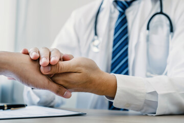 Doctor hands holding patient hand to encourage and explained the health examination results, medical checkup concept