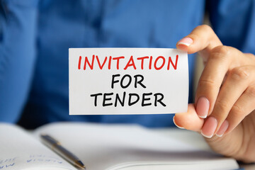 INVITATION FOR TENDER written on a paper card in woman hand