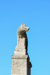 Fototapeta na wymiar Photo of a wolf sculpture against a blue sky
