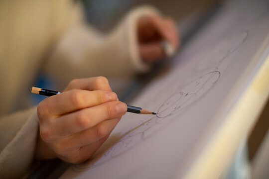 Close up female architect with pencil drafting blueprint