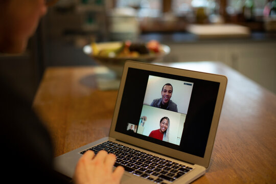 Colleagues video chatting on laptop