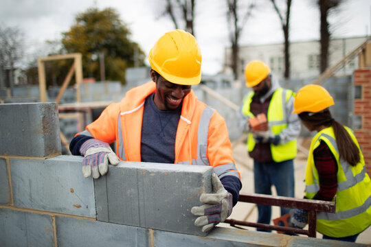 Male construction site laying brick at construction site