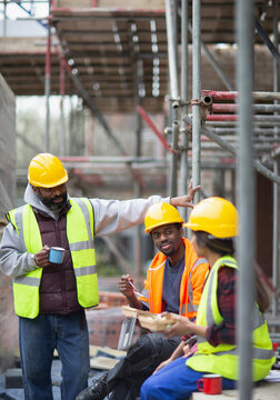 Construction workers enjoying lunch break at construction site
