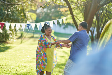 Happy couple dancing in summer park