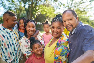 Portrait happy multigenerational family in summer park