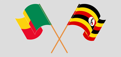 Crossed and waving flags of Benin and Uganda