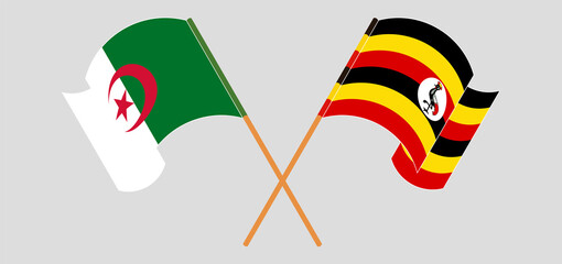 Crossed and waving flags of Algeria and Uganda